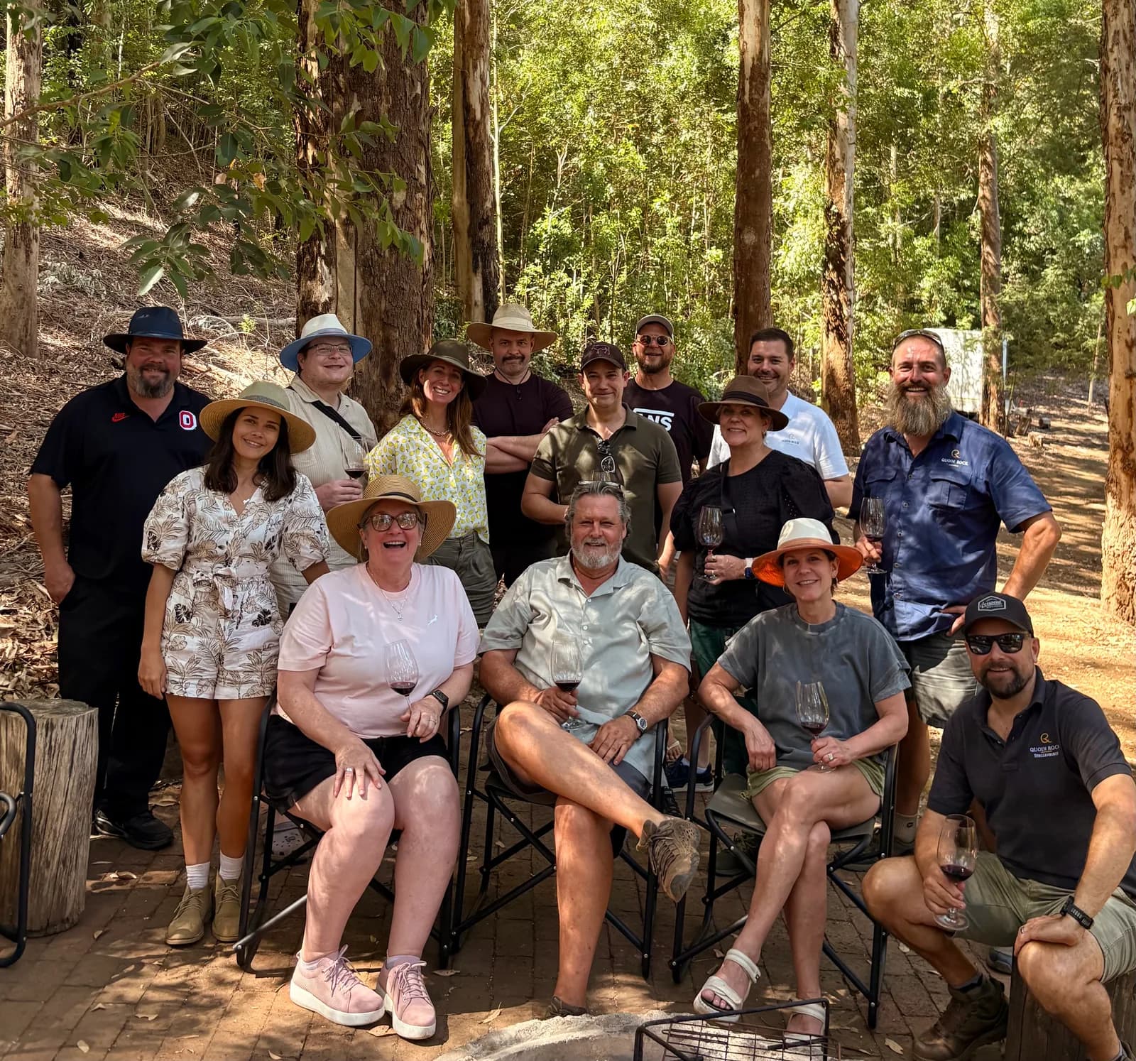 Sharing a glass of red wine with the team among the trees at a South African producer estate
