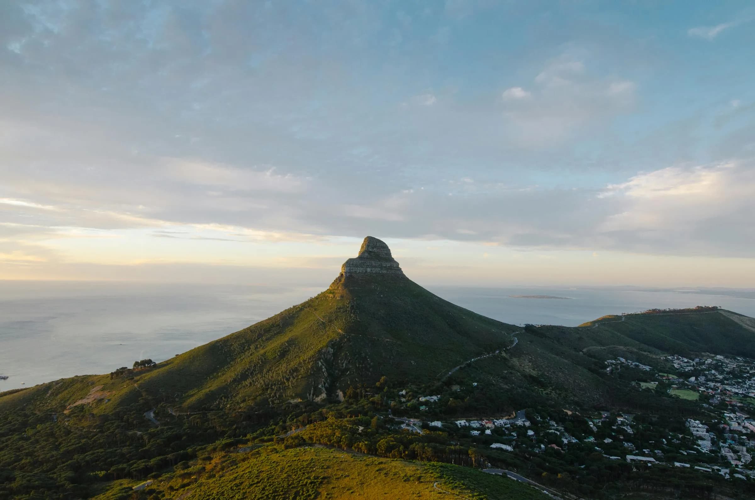Lion's Head at golden hour with Cape Town stretching out below toward the ocean