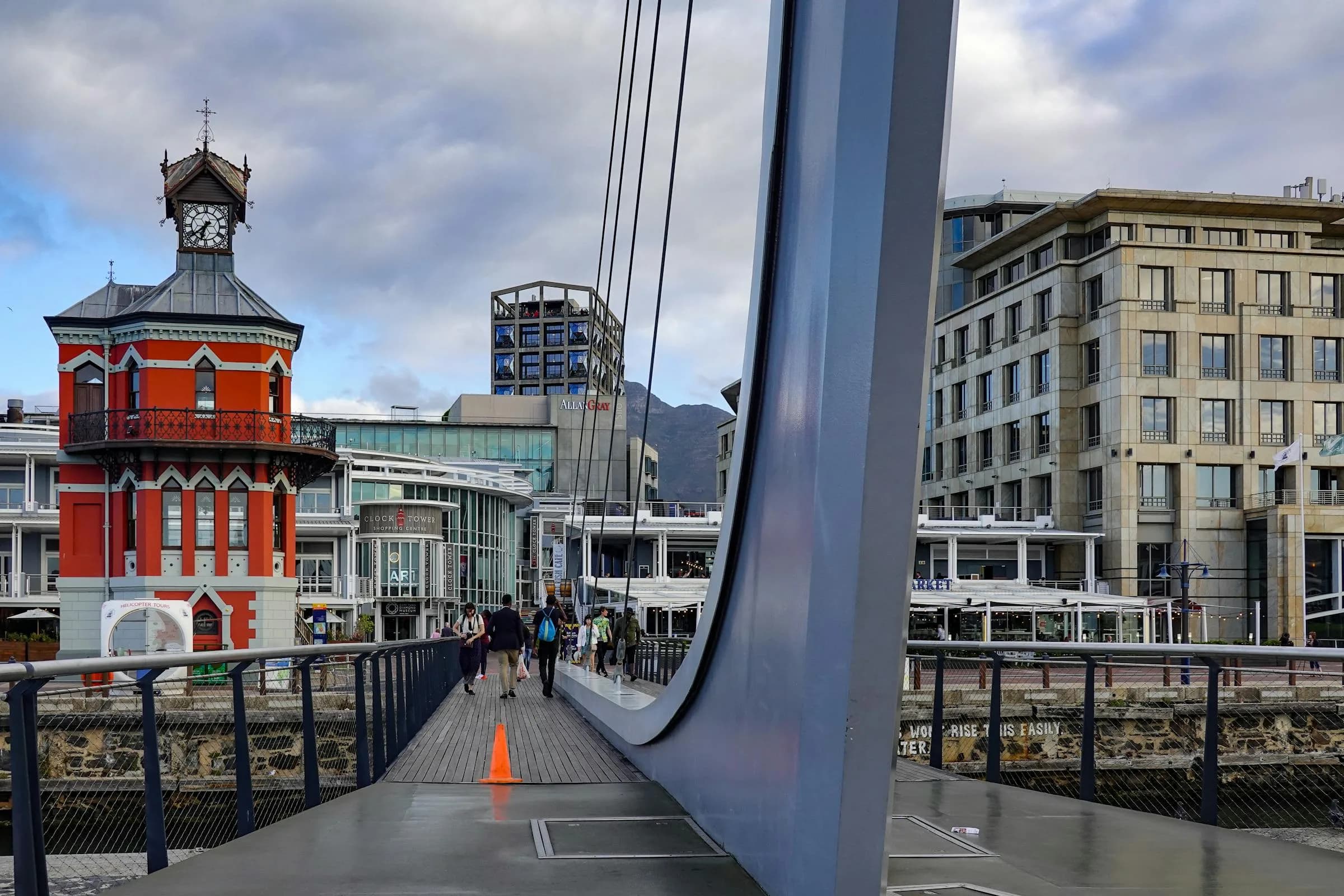 Cape Town's V&A Waterfront with the historic Clock Tower and modern bridges leading toward the harbour