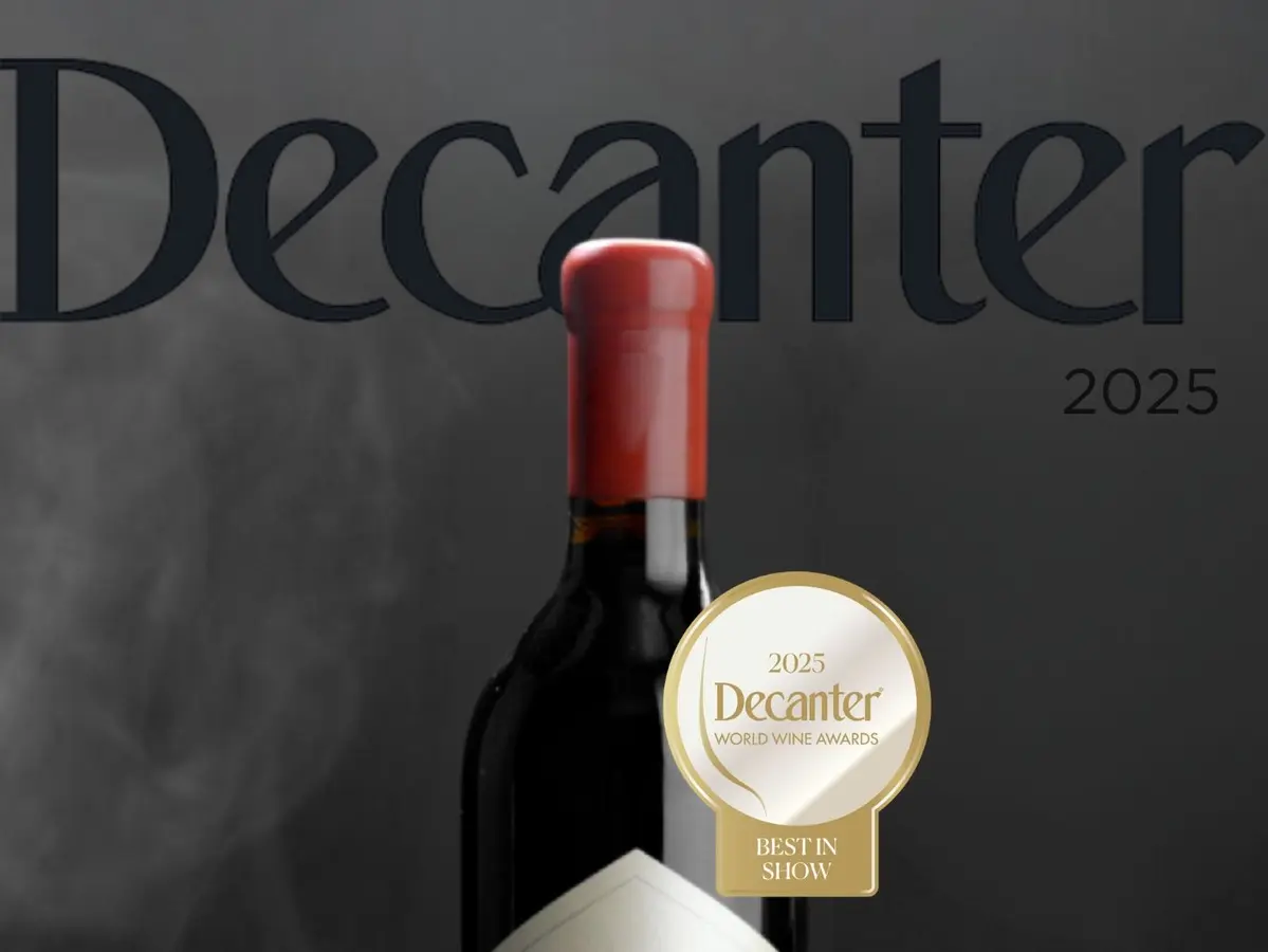 Decanter World Wine Awards 2025 masthead behind a wine bottle wearing a gold Best in Show medallion