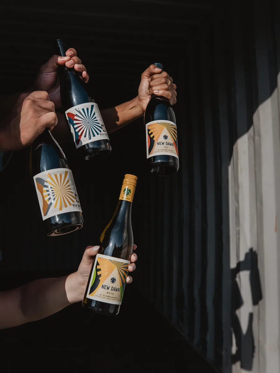 New Dawn bottles held against a dark backdrop