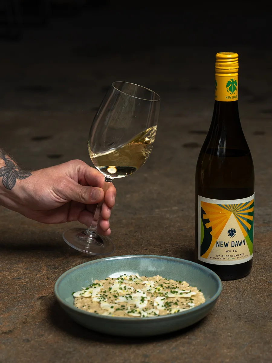 A glass of New Dawn white wine served with food